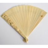 A 19th century Dieppe ivory brise fan, the guards with blank cartouche and deeply carved with