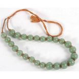 A set of green Peking glass worry beads.
