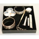 A Victorian silver bangle; a sterling silver bangle decorated with flowers; a silver pin tray; and