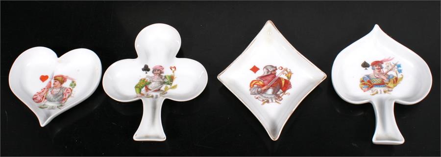 A set of four continental porcelain coasters in the form of playing card suits .