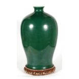 A large Chinese green glazed vase on hardwood stand, with blue six character mark and collection