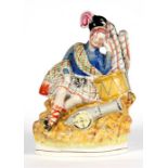 A Victorian Staffordshire figure depicting a Scotsman with a drum and cannon, 28cm (11ins) high.