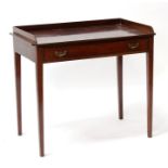 A mahogany writing table with galleried back above a single long frieze drawer, on square tapering