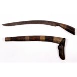 An early Indonesian Badik dagger in its wooden scabbard. Blade length 24cms (9.5ins)