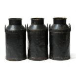 Three Carmarthen black painted milk churns, 67cms (26.5ins) high (a/f) (3).
