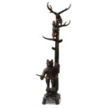 A wooden Black Forest style hall stand carved with a bear and her cubs, 213.5cms (84ins) high).