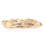 A late 19th century Japanese Meiji period Ivory okimono in the form of two stylised toads and a