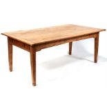A large pine farmhouse kitchen table with a frieze drawer at each end, on square tapering legs,