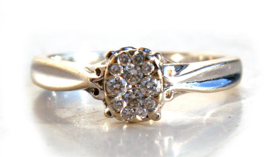 An 18ct white gold twelve-stone diamond ring, UK size 'M / N'.