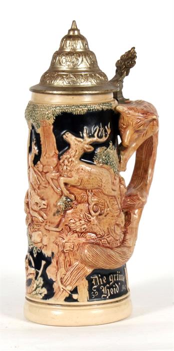 A German pottery stein decorated with deer, the handle modelled as a fox.