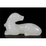 A Chinese Jade carving in the form of a recumbent dog, 6cm (2.25ins) long.