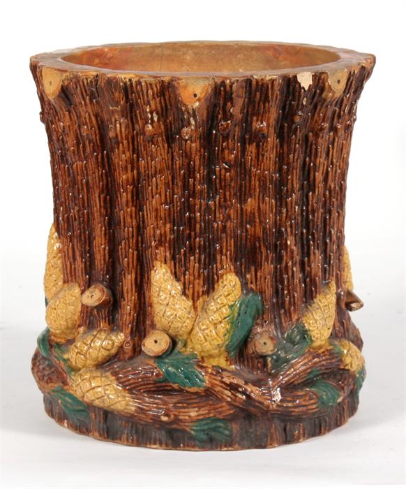 A Victorian majolica vase, decorated in relief with pine cones, 18cms (7ins) high. Condition
