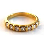 An 18ct gold seven-stone diamond ring, UK size 'K'.