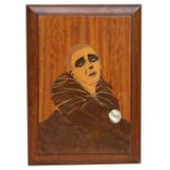 An inlaid wooden panel depicting a Pierrot clown, 28 by 38cms (11 by 15ins).