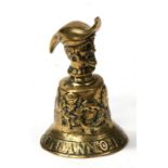 A cast brass bell with Latin inscription to rim, decorated in relief with figures and having a