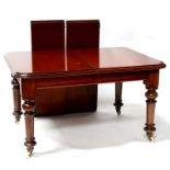 A mahogany extending dining table with two extra leaves, on turned legs, 202cms (79.5ins) wide