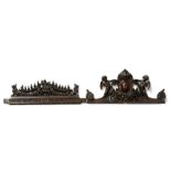 A Victorian carved walnut pediment decorated with winged cherubs and foliate swags, 69cms (27ins)
