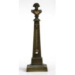 A Victorian brass obelisk desk thermometer, surmounted with a bust of Napoleon, 20cm (8ins) high.
