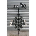 A wrought iron weather vane surmounted with a group of magpies, 130cms (51ins) high.