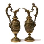 A pair of mid 19th century French bronze classical ewers with cherub decoration, 33cms (13ins)