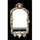 A Sitzendorf style continental porcelain framed mirror, encrusted with flowers, leaves and