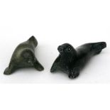 Two Inuit carved greenstone figures in the form of seals, the largest 10cms (4ins) long (2).