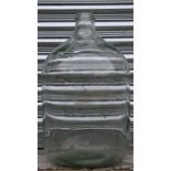 A large glass carboy, 65cms (25.5ins) high.