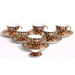 Six Royal Crown Derby Imari pattern cups and saucers; together with a matching miniature cup and