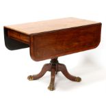 A Regency figured mahogany pedestal Pembroke table with twin flap crossbanded rectangular top,