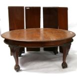 A late 19th century mahogany oval extending dining table with four extra leaves, standing on