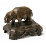 An 18th century bronze figure of an elephant mounted on a plinth with laurel leaf swags, 10cms (