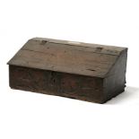 A 17th century oak bible box, the sloped top above a carved frieze, with central date '1686',