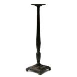 A carved mahogany torchere with tapering reeded column, standing on a square base, 134cms (52.75ins)
