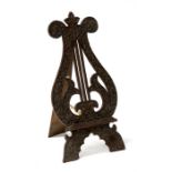 A carved mahogany lyre shaped fretwork table top picture easel, 47cms (18.5ins) high