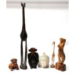 A group of carved wooden figures, including a mermaid and a giraffe.