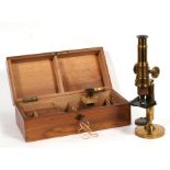 A Victorian lacquered brass microscope, with extra lens, in original box, 27cms (10.25ins) high.