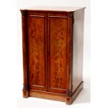 A Victorian figured mahogany bachelor's cupboard, the pair of panelled doors flanked by a pair of