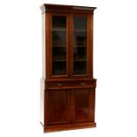 A late 19th century walnut glazed bookcase on cupboard, the pair of glazed doors enclosing a shelved