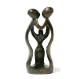 A modern green figured soapstone sculptural group depicting two parents and a child, 38cms (15ins)