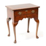 A Georgian style walnut lowboy, the crossbanded rectangular top above a single frieze drawer with