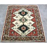 A modern design Belgian rug with three central guls within geometric floral borders, on a cream