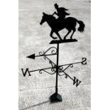 A wrought iron weather vane, surmounted by a horse and rider, 124.5cm (49ins) high.