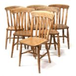A harlequin set of six stripped kitchen chairs.