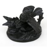 A patented spelter figure of a bird on a rocky outcrop, 9cms (3.5ins) high.