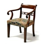 A Georgian mahogany elbow chair with upholstered seat, on square tapering legs.