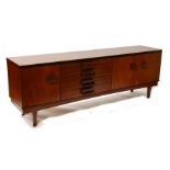 A mid 20th century Danish design teak sideboard with four central drawers flanked by cupboards,