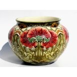 A 19th century Minton jardiniere decorated with stylised poppies, 37cms (14.5ins) wide.