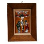 A Limoges enamel plaque depicting the Crucifixion, framed, 9 by 13cms (3.5 by 5.1ins).