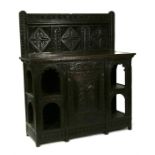 A Victorian carved oak sideboard with central cupboard flanked by arched sections, 139cms (54.75ins)