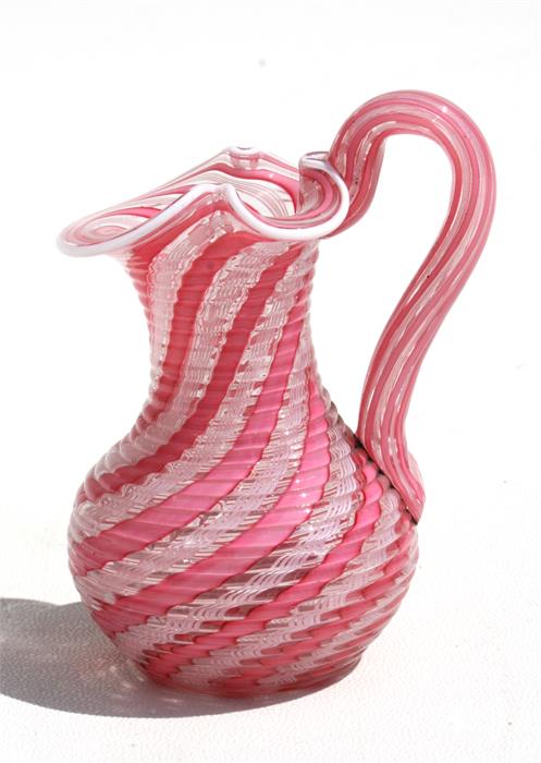 A Venetian pink glass jug with ground out pontil mark to base, 9cms (3.5ins) high. Condition